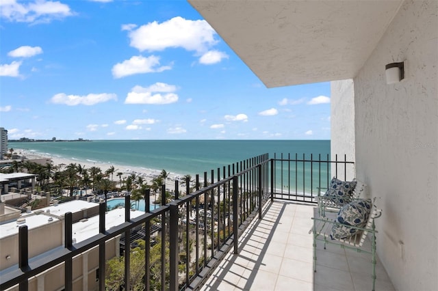 balcony featuring a beach view and a water view