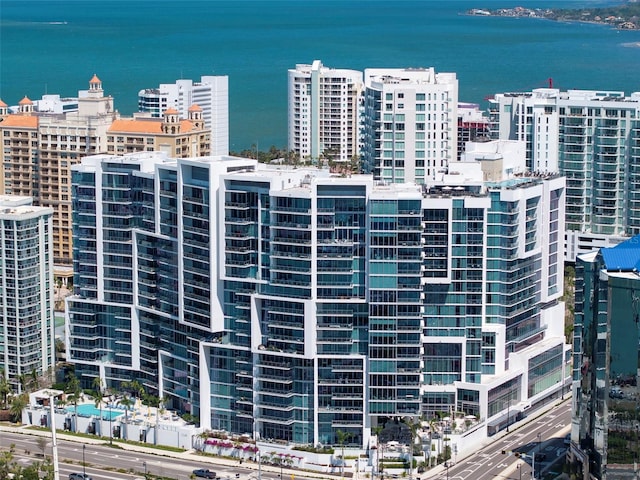 view of building exterior with a city view and a water view