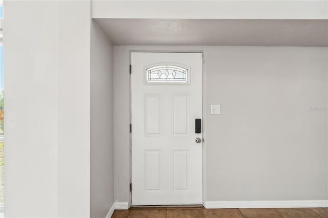 entryway with baseboards and tile patterned floors