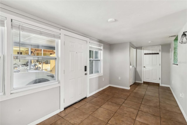 entryway with tile patterned floors and baseboards