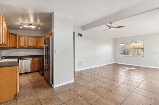 kitchen featuring light tile patterned flooring, appliances with stainless steel finishes, a sink, and visible vents