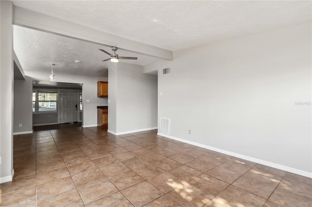 unfurnished living room with baseboards, ceiling fan, light tile patterned floors, and visible vents