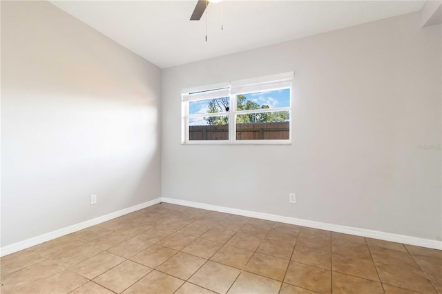 spare room with baseboards and ceiling fan