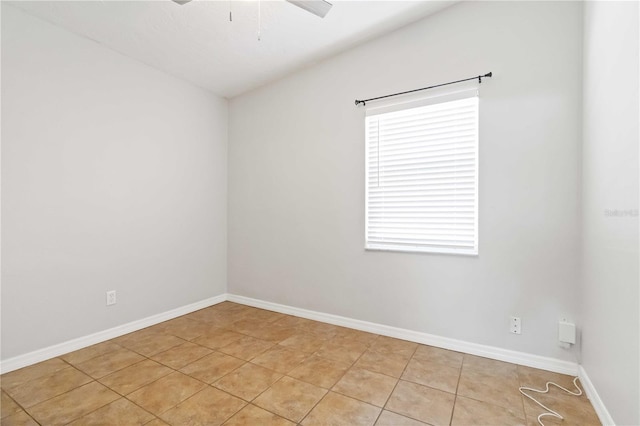 unfurnished room with light tile patterned floors, ceiling fan, and baseboards