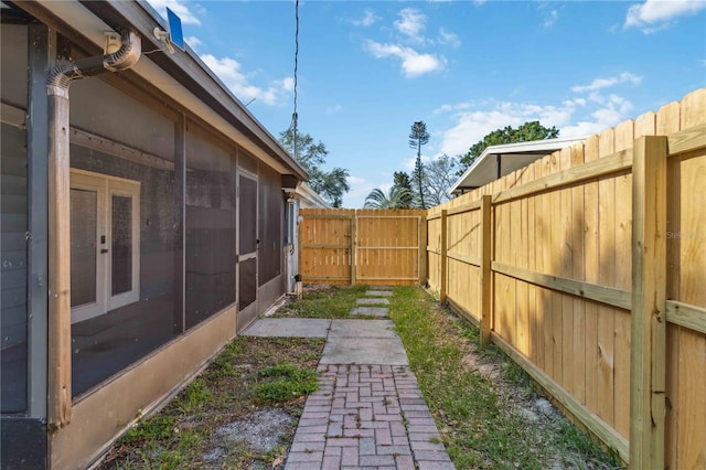 view of yard with a sunroom and a fenced backyard