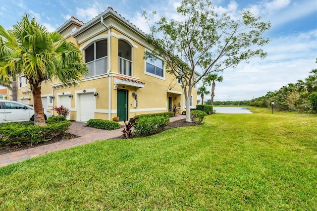 exterior space featuring a water view and an attached garage