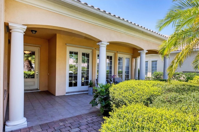 5881 Girona Pl, Sarasota, FL 34238 - entrance to property with stucco siding and french doors