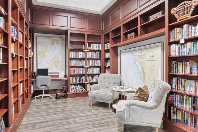 5881 Girona Pl, Sarasota, FL 34238 - living area with bookshelves, light wood-type flooring, and an office area