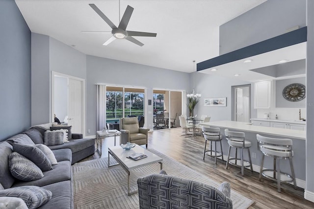 5881 Girona Pl, Sarasota, FL 34238 - living area with high vaulted ceiling, wood finished floors, ceiling fan, and baseboards
