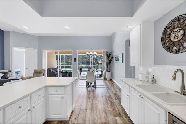 5881 Girona Pl, Sarasota, FL 34238 - kitchen featuring a sink, light wood-style floors, a chandelier, light countertops, and recessed lighting