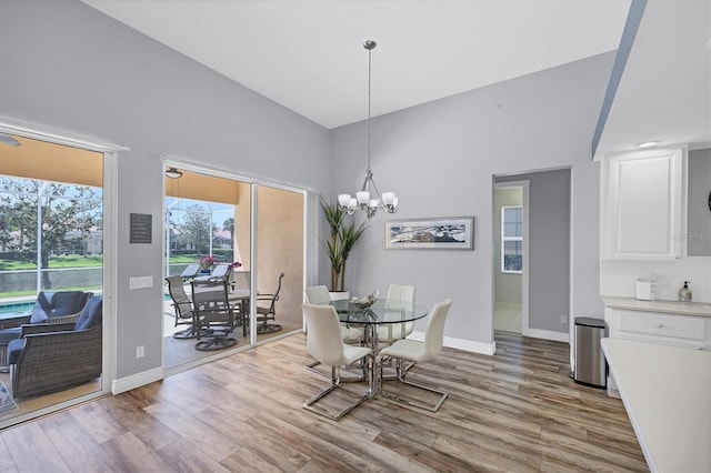 5881 Girona Pl, Sarasota, FL 34238 - dining area featuring wood finished floors, baseboards, and a chandelier