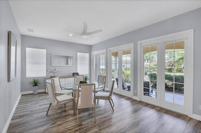 5881 Girona Pl, Sarasota, FL 34238 - dining room featuring baseboards, plenty of natural light, wood finished floors, and a ceiling fan