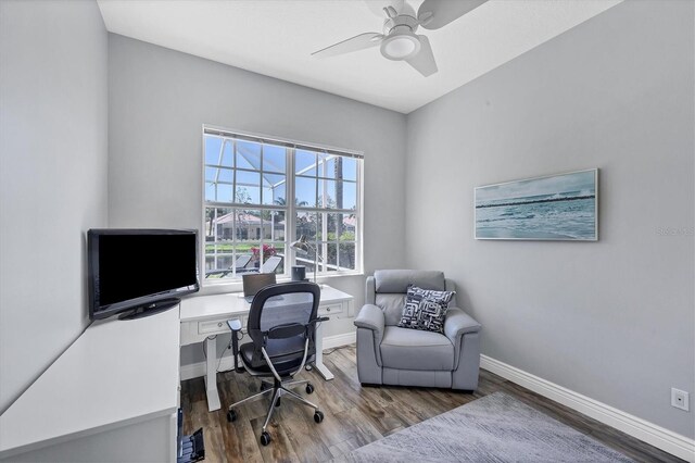 5881 Girona Pl, Sarasota, FL 34238 - home office with wood finished floors, ceiling fan, and baseboards