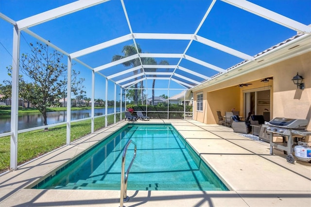 5881 Girona Pl, Sarasota, FL 34238 - swimming pool featuring a water view, a patio area, a ceiling fan, area for grilling, and glass enclosure