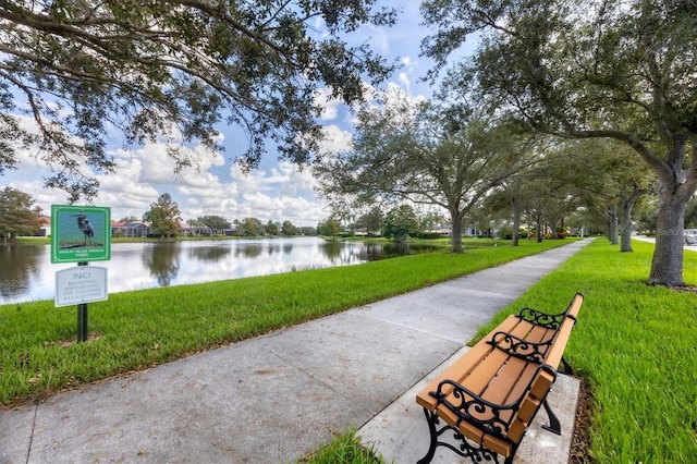 5881 Girona Pl, Sarasota, FL 34238 - view of community with a lawn and a water view