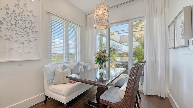 dining area with baseboards, dark wood finished floors, and a healthy amount of sunlight
