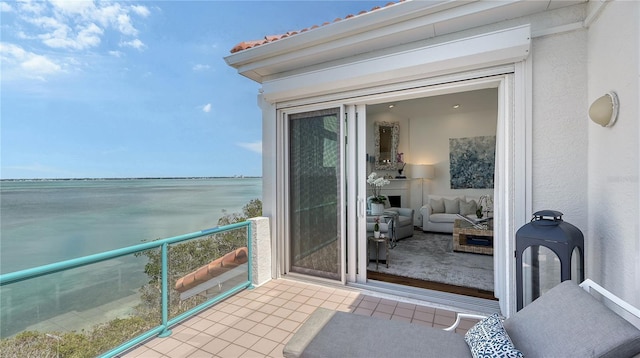 balcony with a water view and an outdoor living space