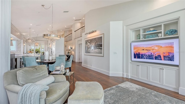 living room featuring recessed lighting, lofted ceiling, dark wood-type flooring, baseboards, and a chandelier