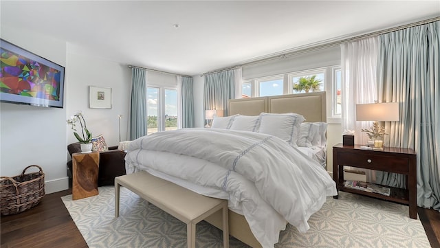 bedroom with wood finished floors and access to exterior