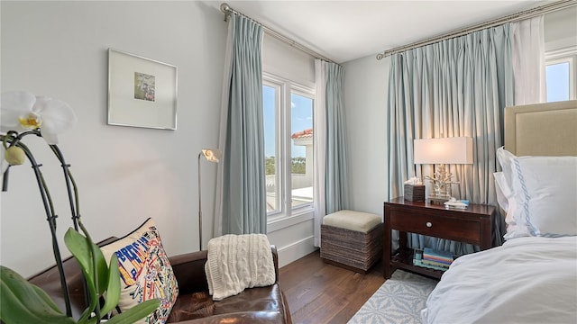 bedroom with wood finished floors and multiple windows