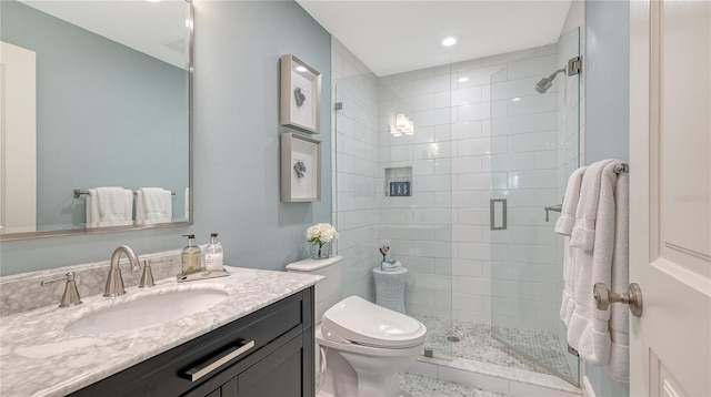 full bathroom with recessed lighting, vanity, toilet, and a stall shower