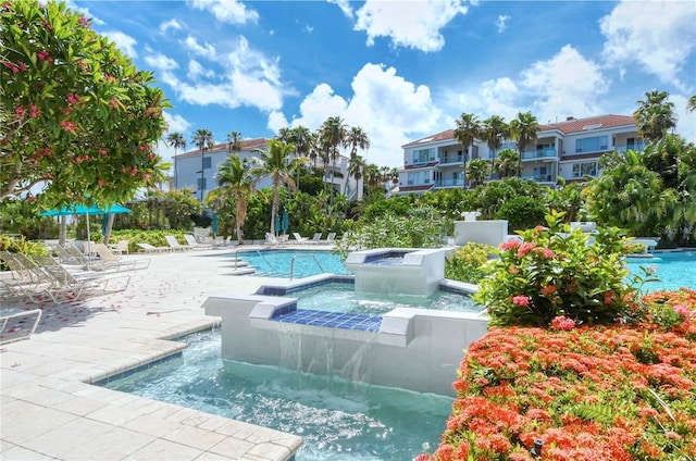 pool featuring a hot tub and a patio