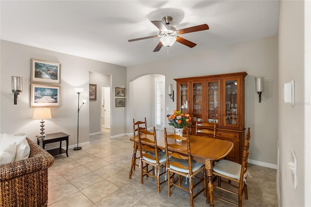 6124 35th Ct E, Bradenton, FL 34203 - dining space featuring baseboards, light tile patterned floors, arched walkways, and ceiling fan