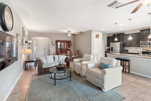 6124 35th Ct E, Bradenton, FL 34203 - living area featuring visible vents, arched walkways, a ceiling fan, and light tile patterned floors
