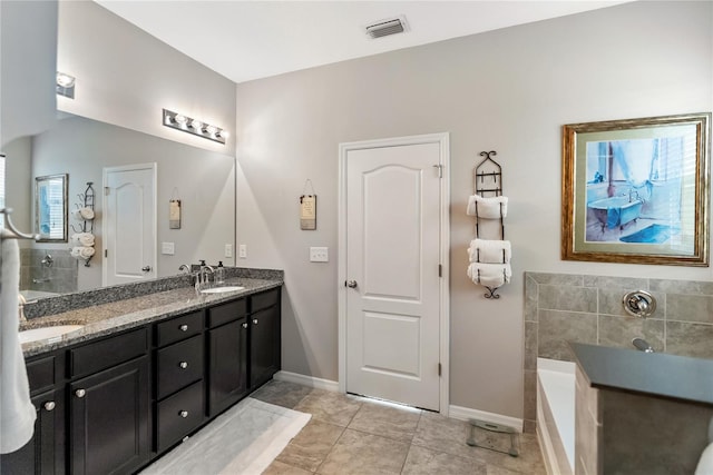 6124 35th Ct E, Bradenton, FL 34203 - bathroom with visible vents, a bath, double vanity, and a sink