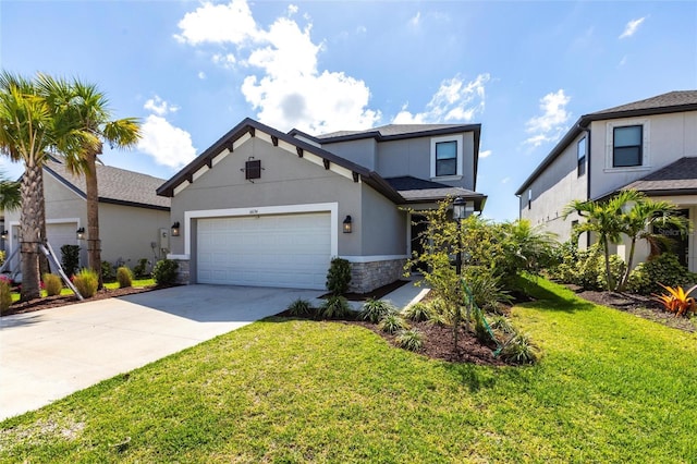 traditional-style home with stucco siding, driveway, stone siding, an attached garage, and a front yard
