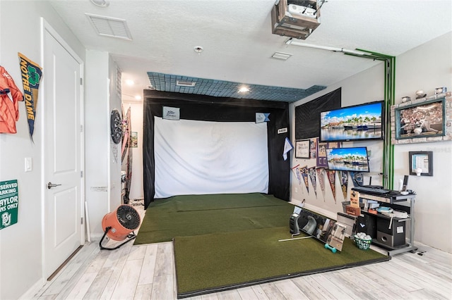 garage with visible vents, baseboards, and a garage door opener