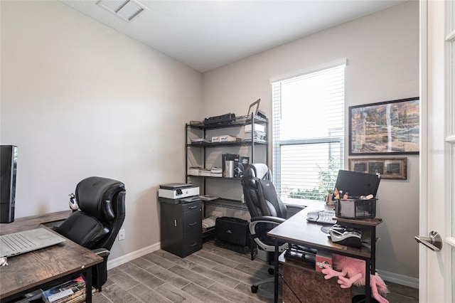 office space with visible vents, baseboards, and wood finished floors
