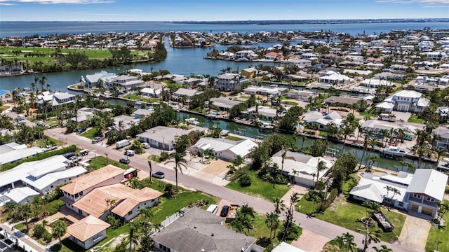 birds eye view of property with a water view and a residential view