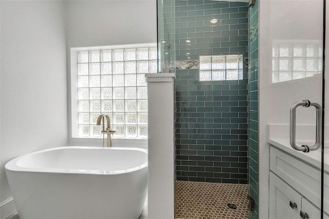 full bath with a shower stall, a freestanding tub, and plenty of natural light