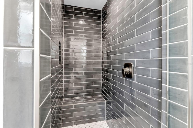 bathroom with tiled shower