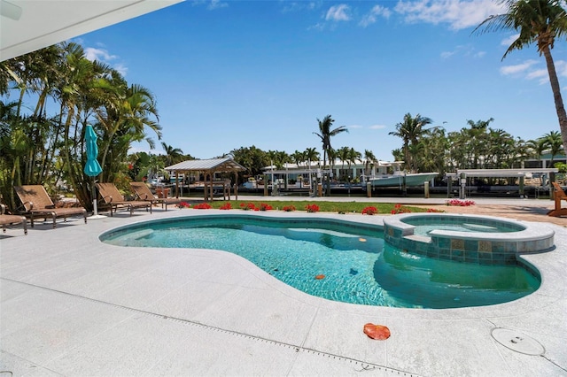 view of pool featuring a pool with connected hot tub and a patio