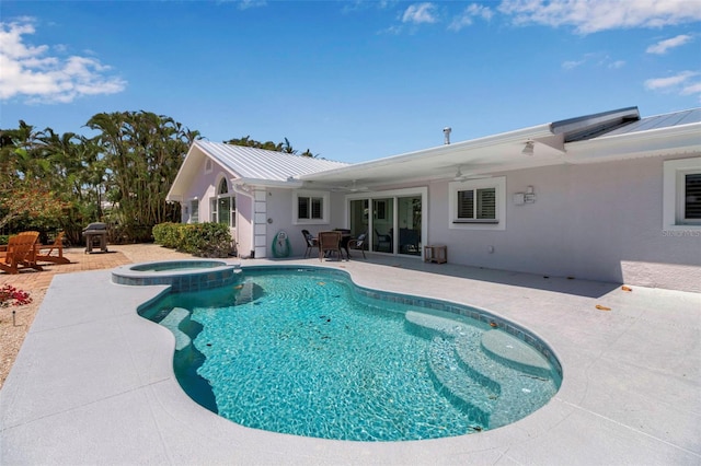 view of pool featuring a pool with connected hot tub, a patio area, and ceiling fan