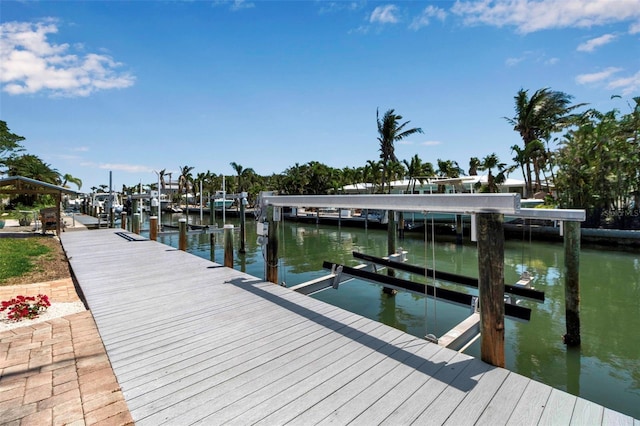 view of dock with boat lift and a water view