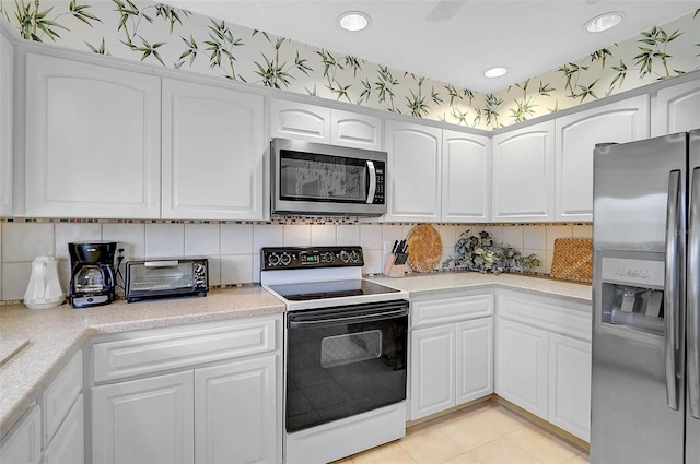 4360 Presidential Avenue Cir E, Bradenton, FL 34203 - kitchen with white cabinetry, appliances with stainless steel finishes, a toaster, and backsplash
