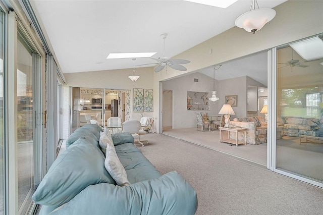 4360 Presidential Avenue Cir E, Bradenton, FL 34203 - living room with a healthy amount of sunlight, carpet flooring, a ceiling fan, and lofted ceiling with skylight