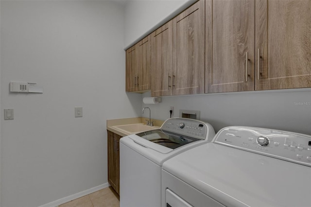 4044 Penshurst Park, Sarasota, FL 34235 - laundry room with baseboards, light tile patterned floors, cabinet space, washer and dryer, and a sink