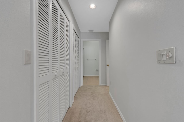 4044 Penshurst Park, Sarasota, FL 34235 - hallway with visible vents, baseboards, and light colored carpet