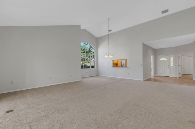 4044 Penshurst Park, Sarasota, FL 34235 - unfurnished living room featuring visible vents, baseboards, a notable chandelier, high vaulted ceiling, and light carpet