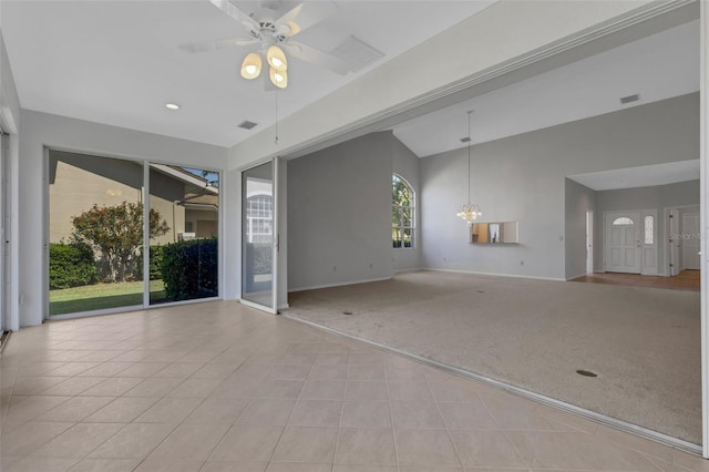 4044 Penshurst Park, Sarasota, FL 34235 - tiled empty room featuring visible vents, baseboards, carpet floors, ceiling fan with notable chandelier, and high vaulted ceiling