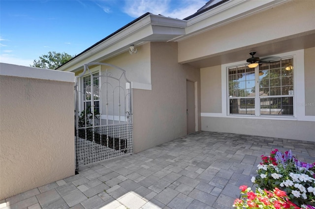 4044 Penshurst Park, Sarasota, FL 34235 - doorway to property featuring ceiling fan, a patio area, and stucco siding