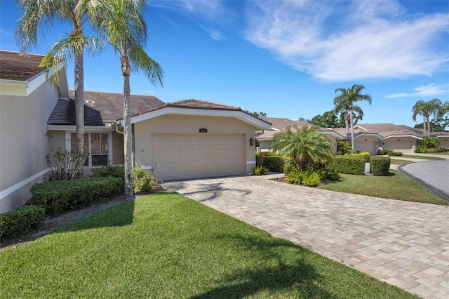4044 Penshurst Park, Sarasota, FL 34235 - ranch-style home with a tiled roof, an attached garage, stucco siding, a front lawn, and driveway