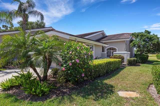 4044 Penshurst Park, Sarasota, FL 34235 - view of side of property with a yard and stucco siding