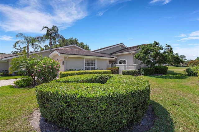 4044 Penshurst Park, Sarasota, FL 34235 - view of front of property with a front yard, a garage, and stucco siding
