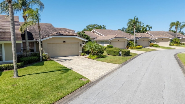 4044 Penshurst Park, Sarasota, FL 34235 - view of front of house featuring a front yard, a garage, stucco siding, a residential view, and driveway