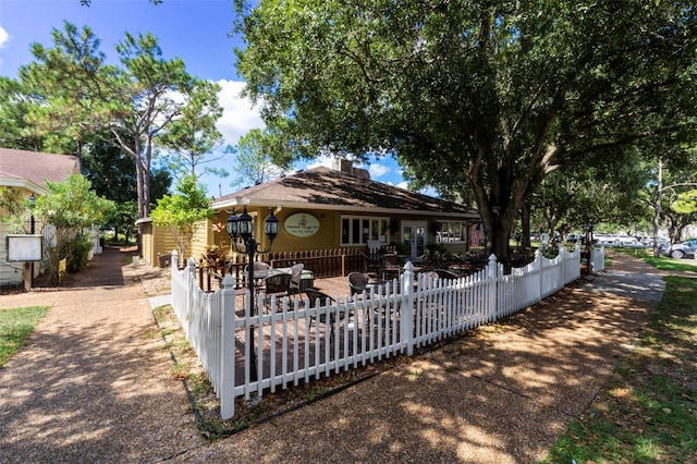 4044 Penshurst Park, Sarasota, FL 34235 - view of front facade with a patio and fence